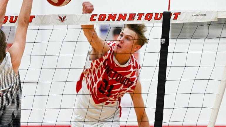 Erick Duignan of Connetquot goes up for a spike during a...