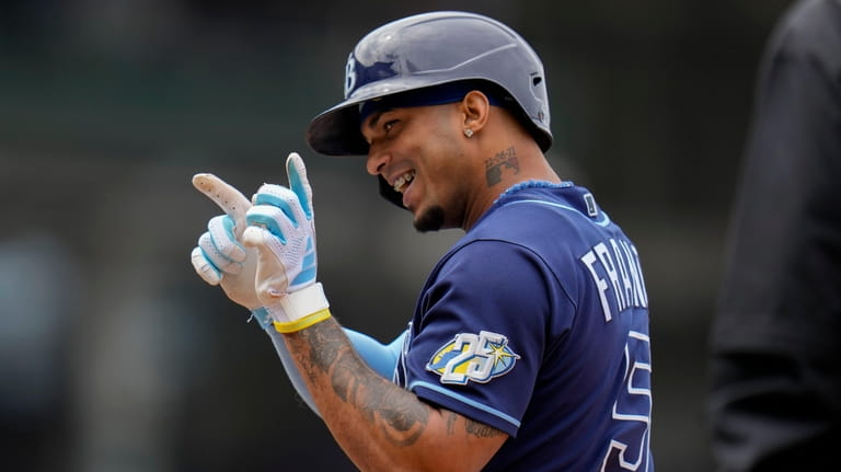 Tampa Bay Rays' Wander Franco points at his dugout after...