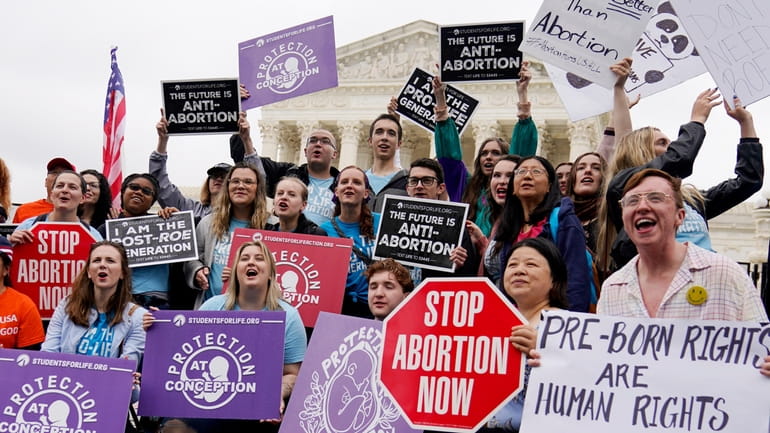 Pro-abortion rights and anti-abortion demonstrators protest outside the U.S. Supreme...