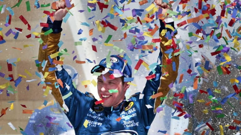 NASCAR driver Brad Keselowski celebrates in victory lane after winning...