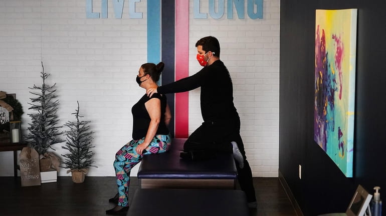 Lisa Santoiemma gets stretched by flexologist Terence Kraemer, of Oyster...