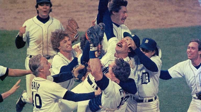 Detroit pitcher Willie Hernandez is mobbed by teammates after the...