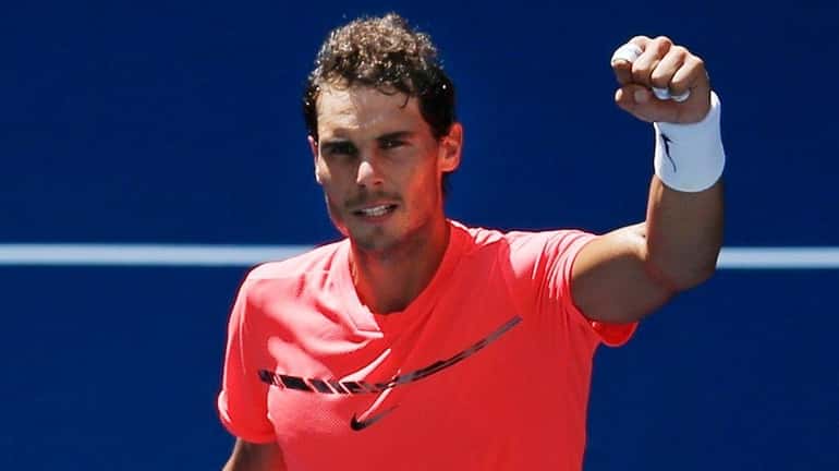 Rafael Nadal waves to fans after beating Alexandr Dolgopolov in...
