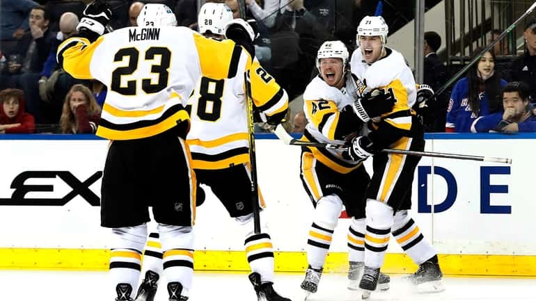 Evgeni Malkin #71 of the Pittsburgh Penguins celebrates his triple...