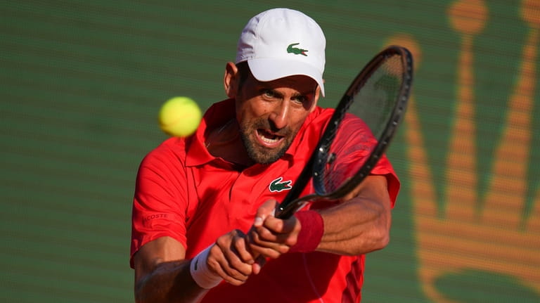 Serbia's Novak Djokovic returns the ball to Casper Ruud, of...