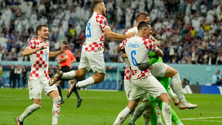 Croatian players celebrate after deafeating Japan during the World Cup...