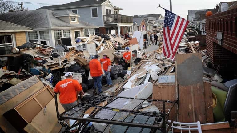 People with the charity group Samaritan's Purse help homeowners on...