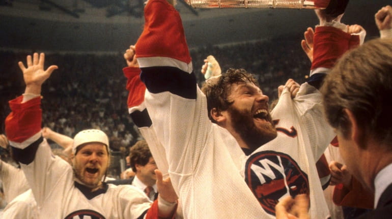 Denis Potvin of the Islanders celebrates with the Stanley Cup Trophy...