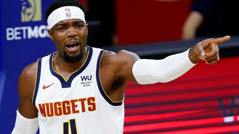 Paul Millsap #4 of the Denver Nuggets reacts to a...