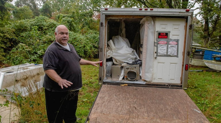 Andrew Sirico shows one of the trailers containing asbestos waste...