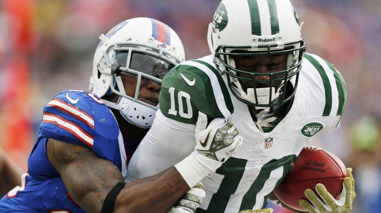 Santonio Holmes is knocked out of bounds by Buffalo Bills...