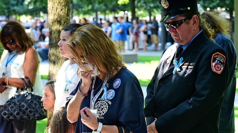 Kristen Alverson cries during a moment of silence at the...