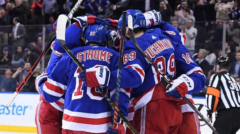 New York Rangers players celebrate a power-play goal by center...