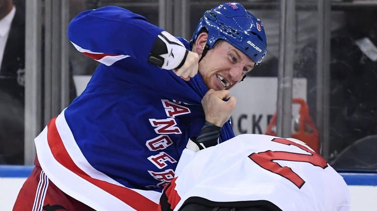 New York Rangers left wing Cody McLeod fights New Jersey...