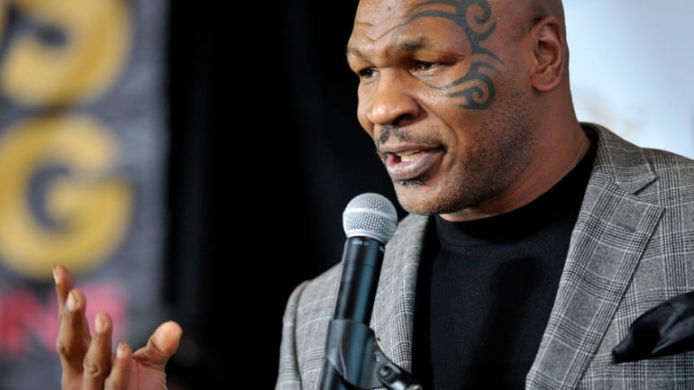 FILE - Former boxer Mike Tyson holds a news conference...
