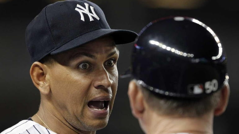 Alex Rodriguez talks to Yankees first base coach Mick Kelleher...