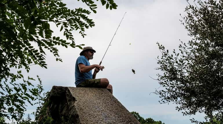 Joe Cotter, of East Meadow, catches a fish at the...