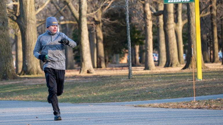 A runner in Eisenhower Park checks his watch on Saturday.