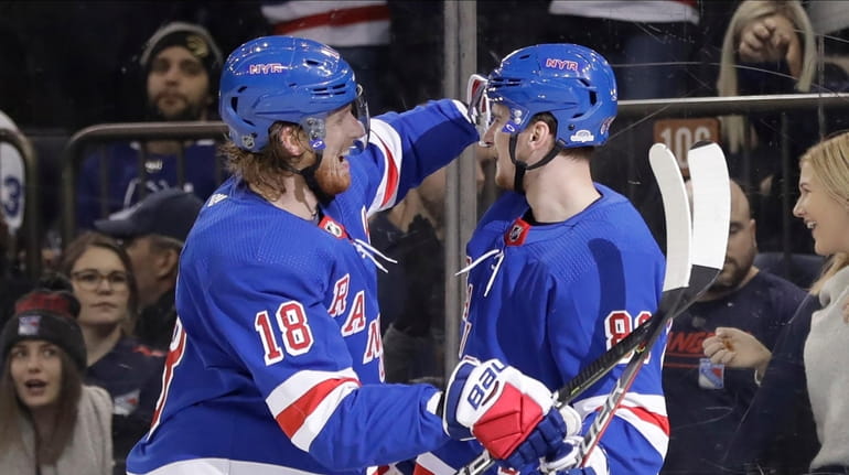 Rangers' Marc Staal, left, hugs Pavel Buchnevich after Buchnevich scored...