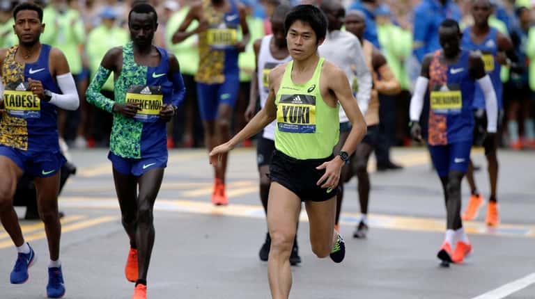 Yuki Kawauchi, winner of the 2018 Boston Marathon, warms up before...