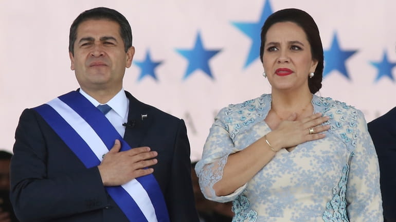 Honduran President Juan Orlando Hernandez, left, stands with his wife...