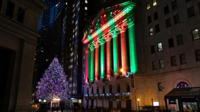 The NYSE is bathed in holiday light on Tuesday in Manhattan.