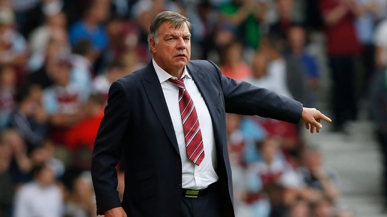 West Ham United's manager Sam Allardyce reacts as he watches...