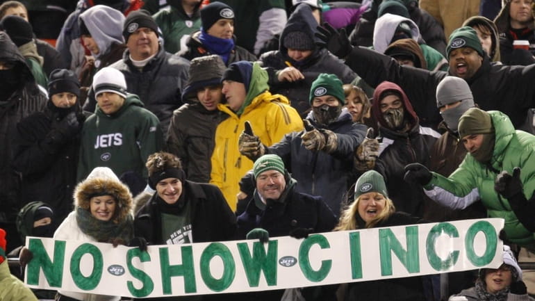 New York Jets fans hold a sign referring to Cincinnati...