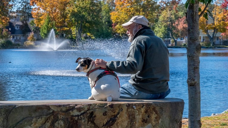 Steve Muller of Huntington sits with his Jack Russell Terrier,...
