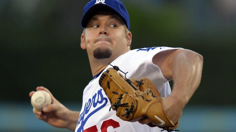 Los Angeles Dodgers starting pitcher Joe Blanton throws to the...