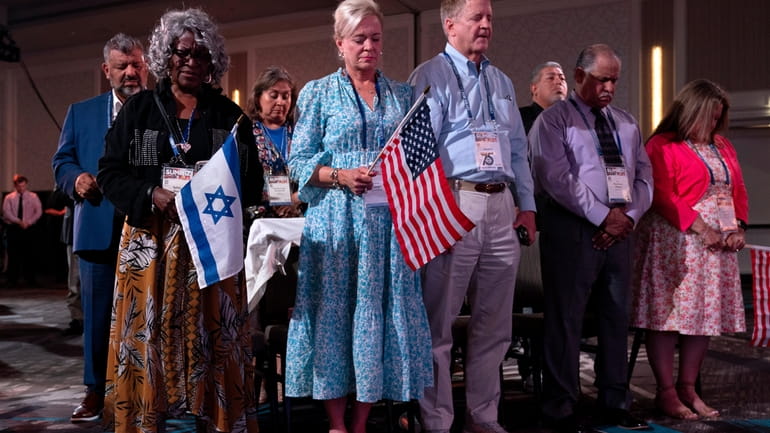 Holding U.S. and Israeli flags, a crowd of largely Evangelical...