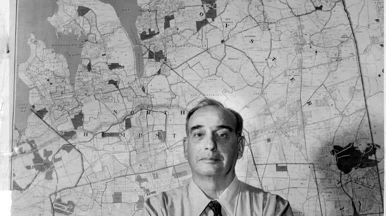 Robert Moses in front of map of Long Island. in...