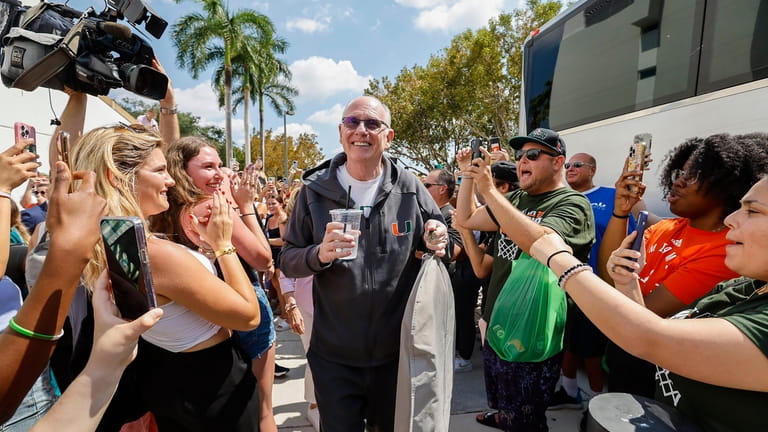 Miami men's NCAA college basketball head coach Jim Larrañaga greets...