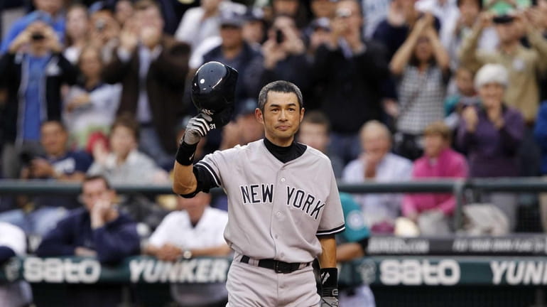 Ichiro Suzuki doffs his batting helmet as fans cheer as...