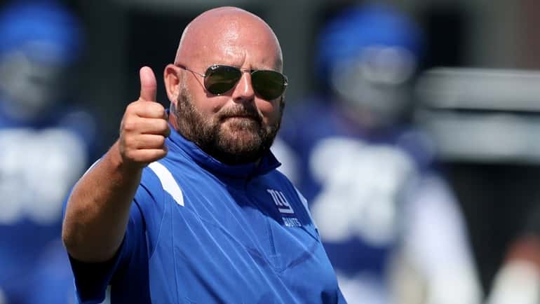 Giants head coach Brian Daboll gives a thumbs-up during training camp...