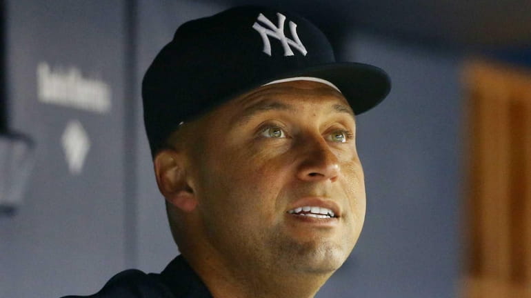 Yankees shortstop Derek Jeter looks on from the dugout during...