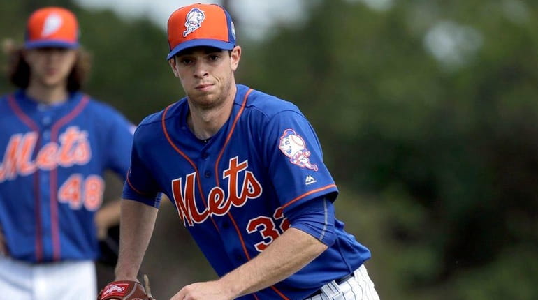 New York Mets pitcher Steven Matz chases a grounder during...