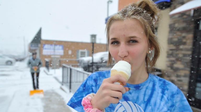 A high school student enjoys ice an cream cone in...