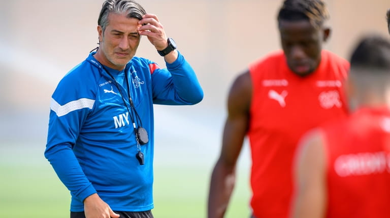 Switzerland's head coach Murat Yakin, left, attends an open training...