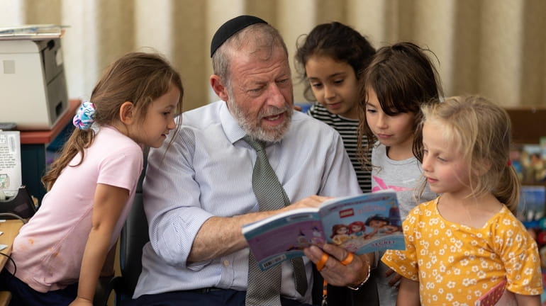Rabbi Kalman Fogel, principal at Mercaz Academy in Plainview, reads...