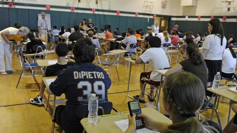 Eighth-grade students prepare to take a Regents exam. (June 18,...