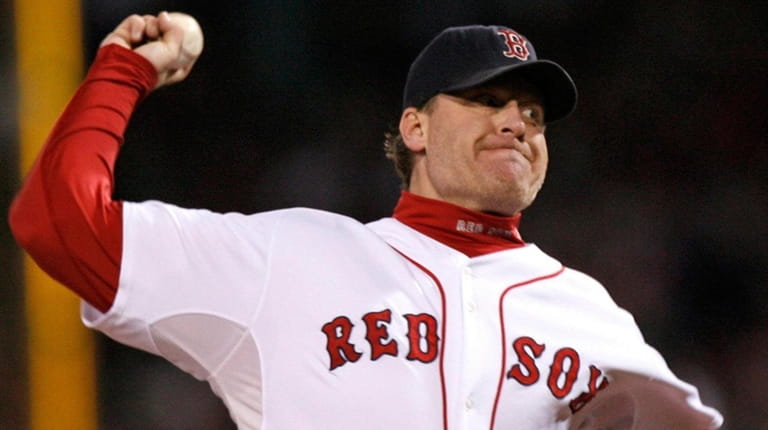The Red Sox's Curt Schilling pitches against the Rockies in...