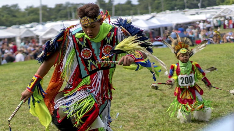 Competitors perform during an exhibition at the annual Shinnecock Powwow...