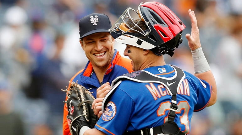 Jacob deGrom and James McCann of the Mets celebrate after defeating...