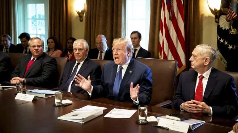 U.S. President Donald Trump, second right, speaks while Rex Tillerson,...