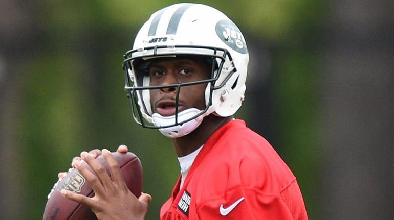New York Jets quarterback Geno Smith looks to pass the...