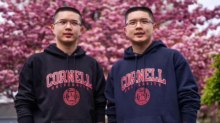 Hicksville High School valedictorian Sam Zhen, left, and his brother...