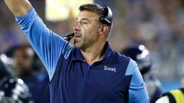 Titans head coach Mike Vrabel signals to his players in...