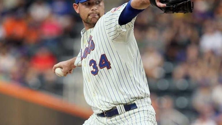 Mike Pelfrey (#34) of the New York Mets delivers a...