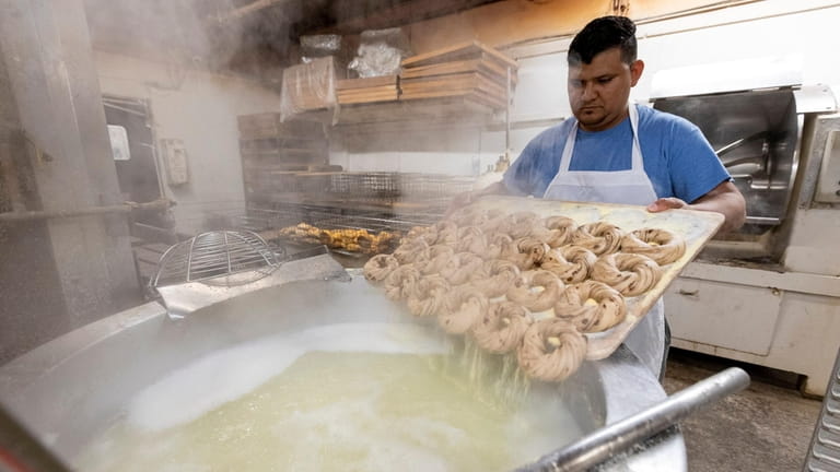Simon Reyes makes bagels at the Bagel Boss on Tuesday,...